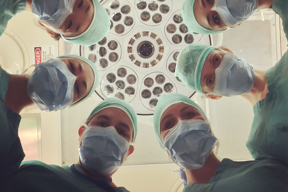 Surgical team at work under operating theatre lights