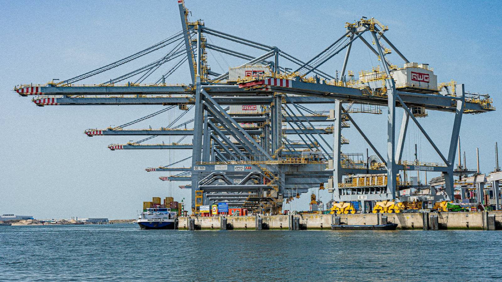 Container cranes at a busy shipping terminal