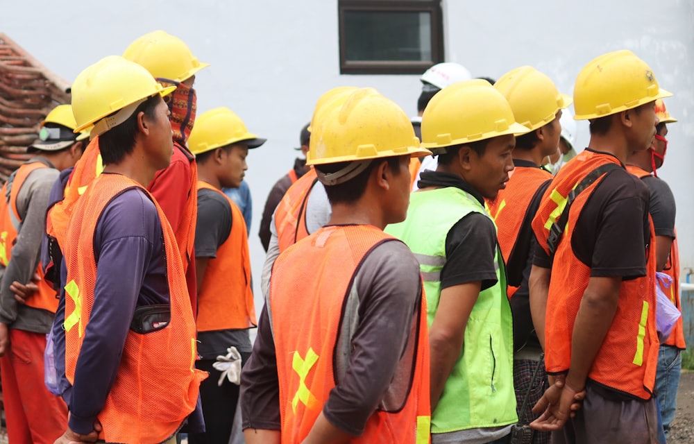 Site worker in an orange vest and yellow hard hat
