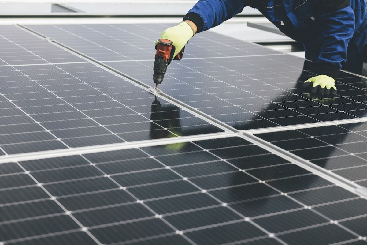 Technician servicing panels on a solar installation